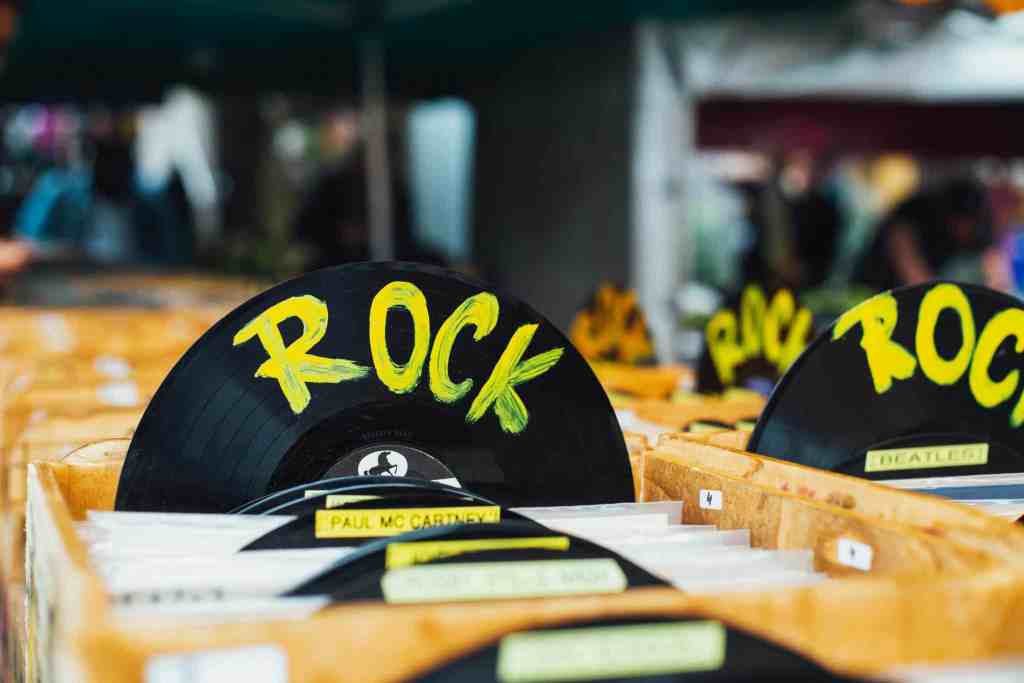 Colorful vinyl records labeled 'Rock' in a vintage music shop, perfect for music enthusiasts.
