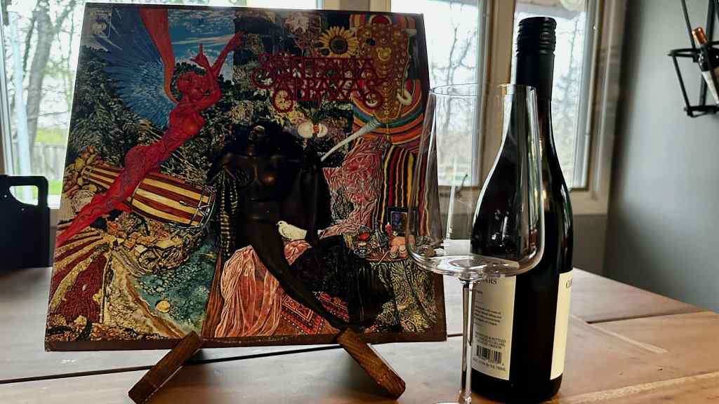 Santana Abraxas with a bottle of wine & glass.