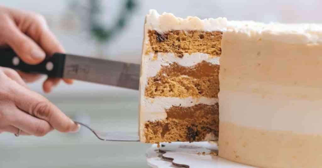 Person cutting a cake