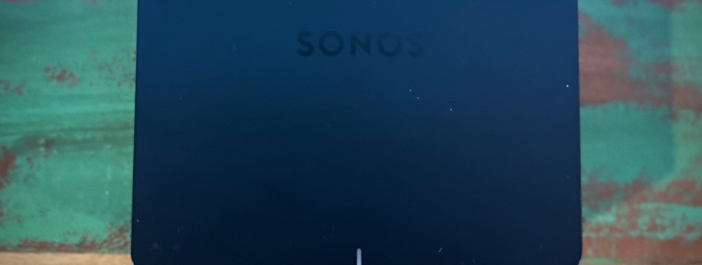 Sonos Port review image showing top view on wood surface in turntable setup