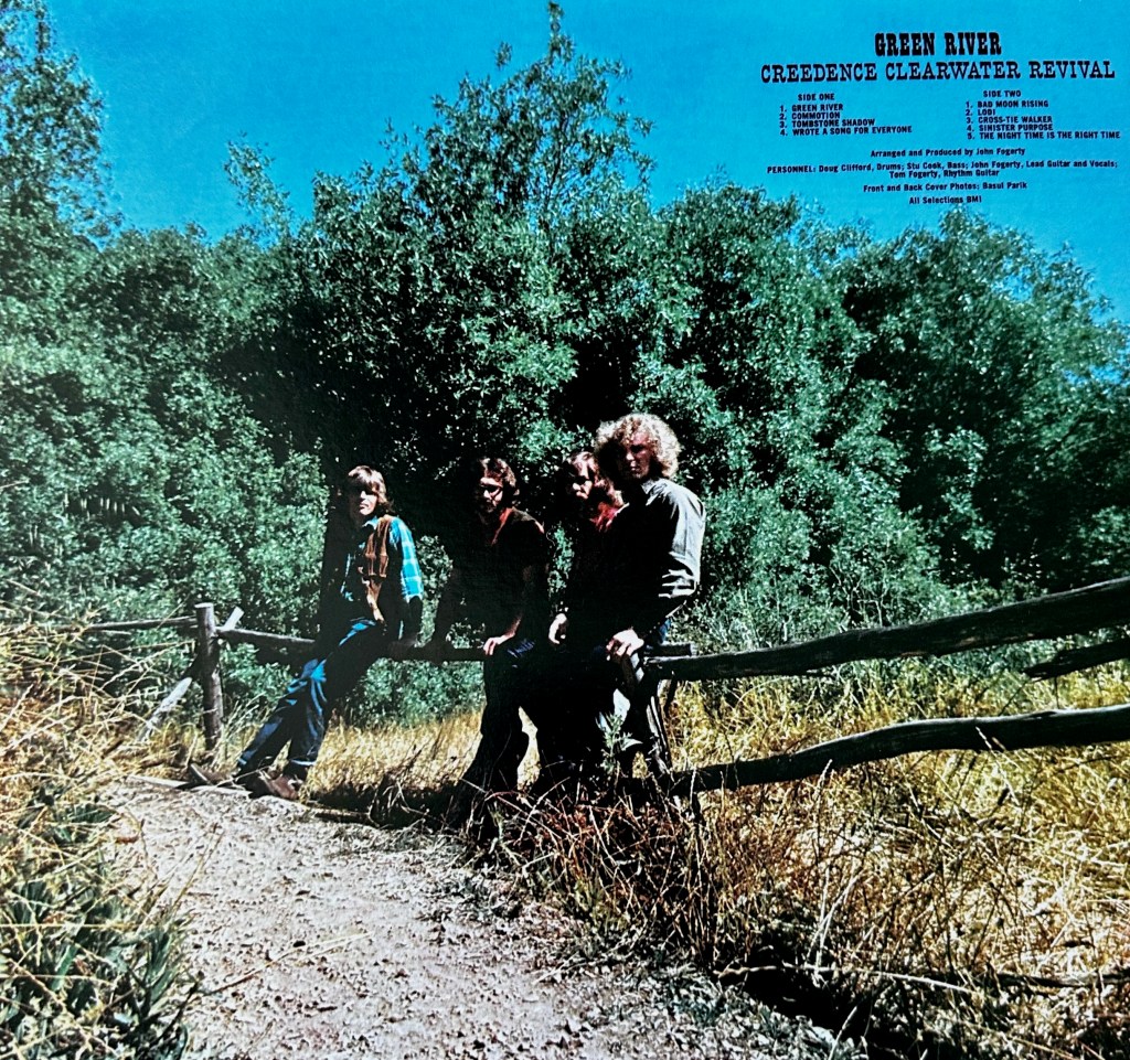 Back cover of Creedence Clearwater Revival’s Green River vinyl album showing the band beside a split-rail fence with the original track listing and album credits.