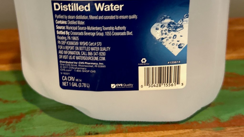 One-gallon container of distilled water used for cleaning vinyl records without leaving mineral residue.