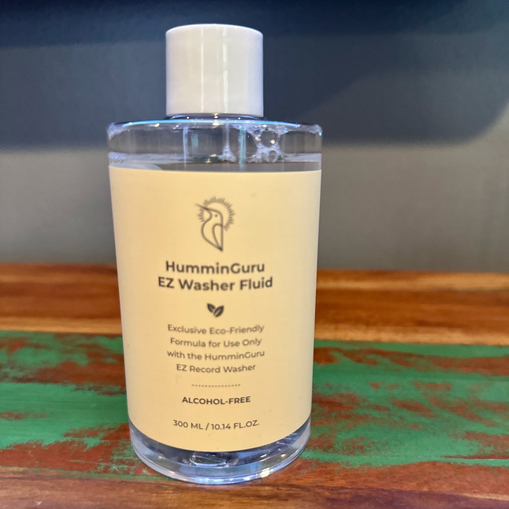 Bottle of HumminGuru EZ Record Washer alcohol-free cleaning fluid included with the manual vinyl record cleaning kit.