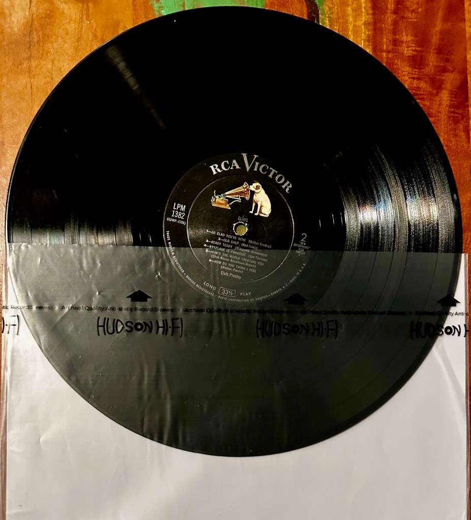 Elvis Presley vinyl record partially inserted into a Hudson Hi-Fi anti-static inner sleeve