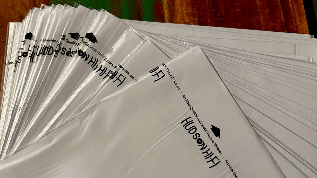 Stack of Hudson Hi-Fi anti-static vinyl record inner sleeves on a wooden table