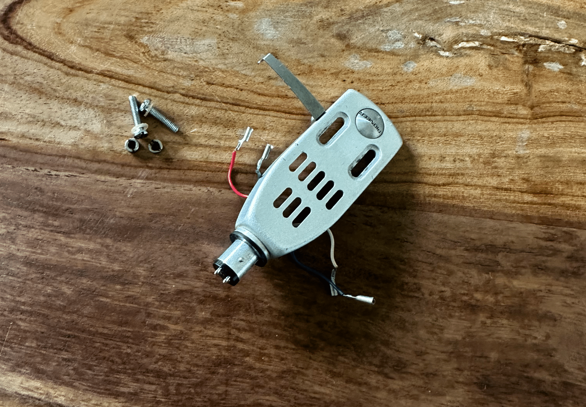 Vintage Pioneer headshell with cartridge leads and mounting hardware for a Pioneer PL-12D turntable