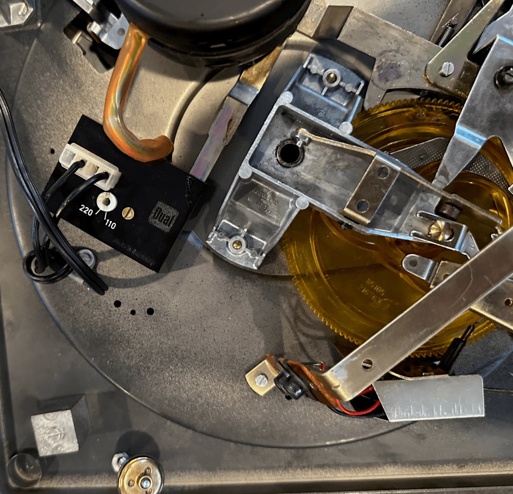 Dual 1219 underside showing opening where multi-play mechanism components fell out during shipping