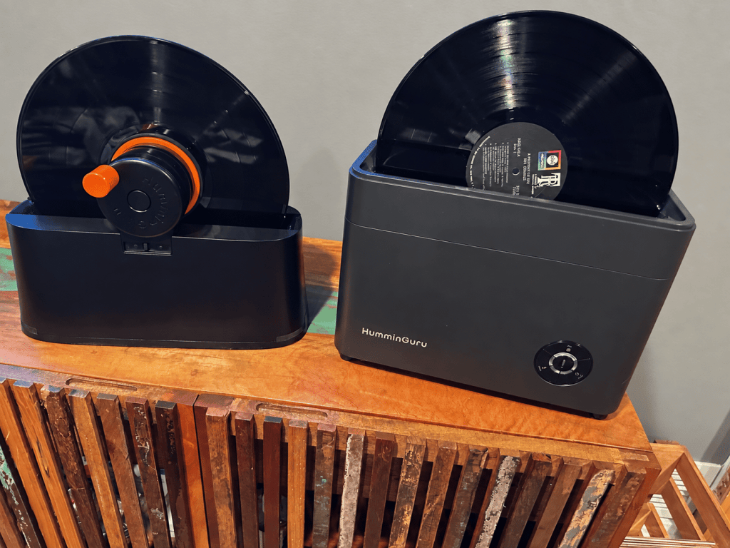 HumminGuru EZ and HG01 record cleaners shown side by side with vinyl records loaded.