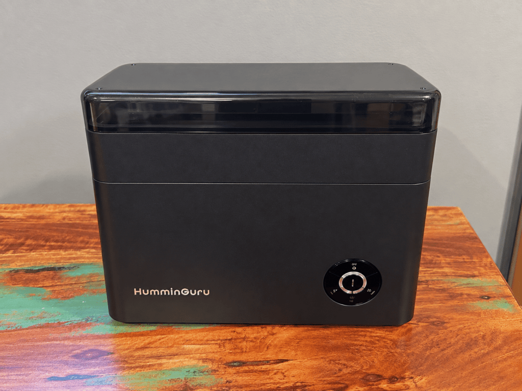 HumminGuru HG01 ultrasonic record cleaner displayed on a wooden tabletop.
