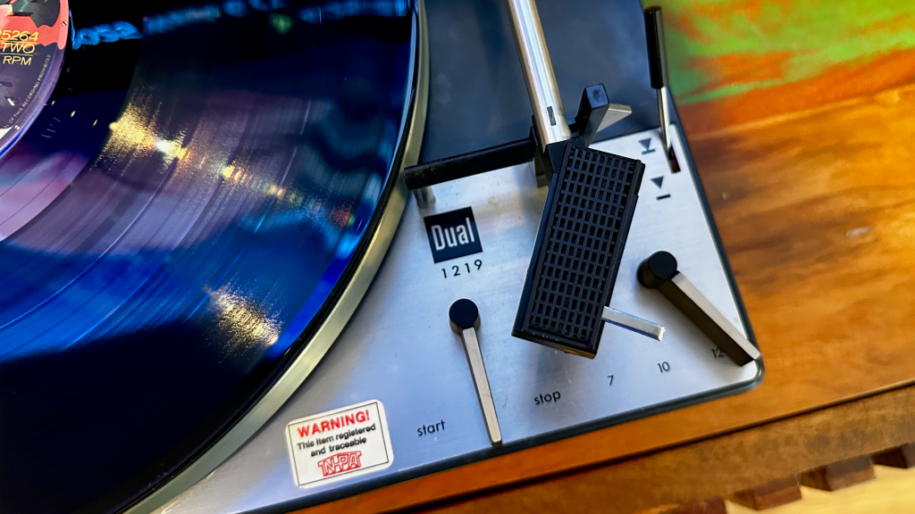 Dual 1219 top plate showing old warning sticker before removal during restoration